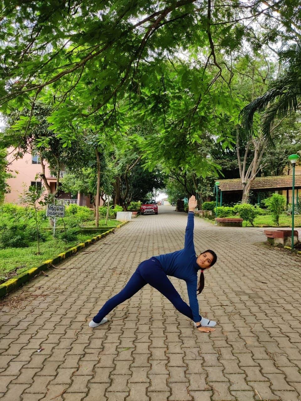 Triangle pose on university grounds